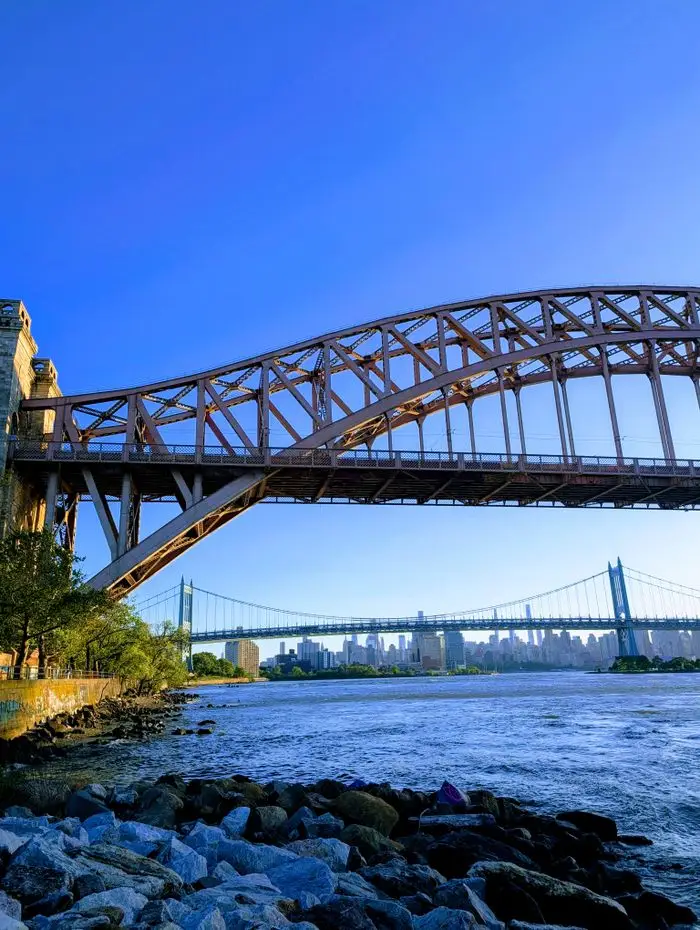 Capture of Hell Gate and RFK bridges with New York City skyline in the backdrop.